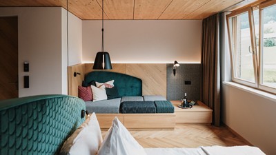Modern room in the Hotel Adler Au with a cozy seating area, wooden accents and stylish details.